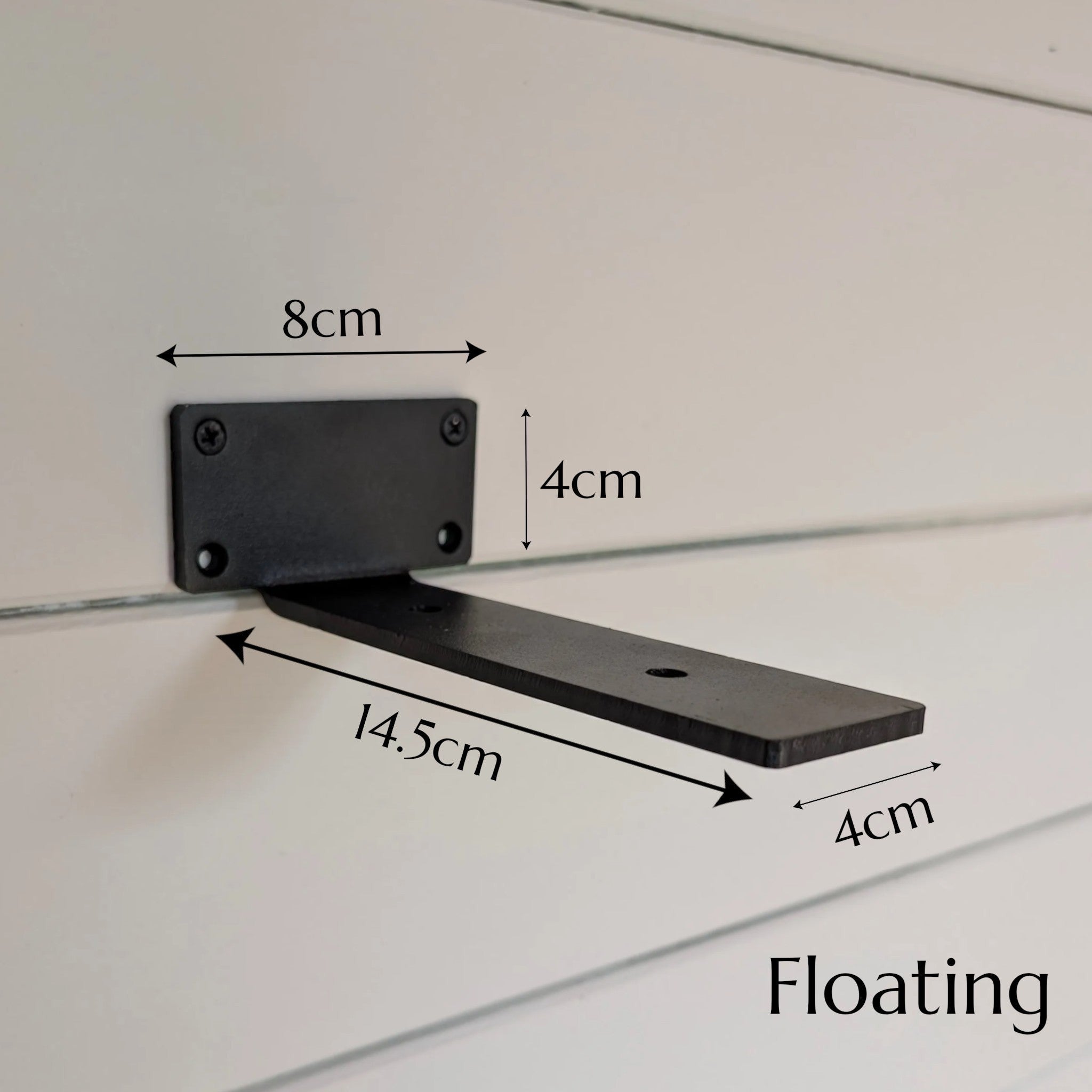 Thriverton black cast-iron floating shelf bracket with dimensions labeled on a white wall