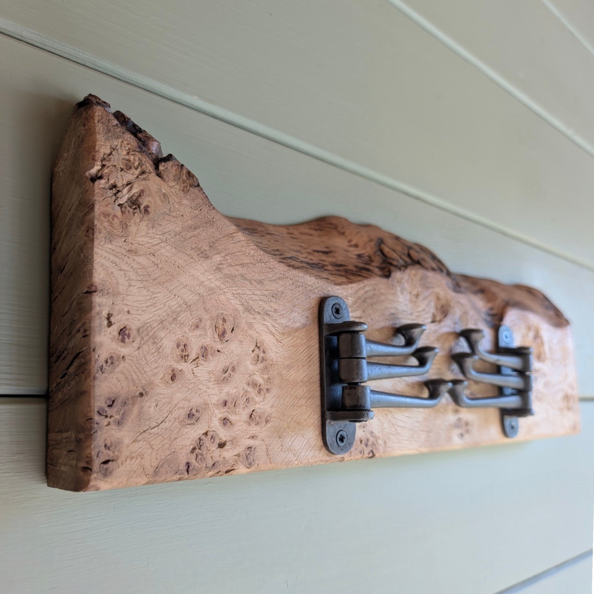 Thriverton hand-crafted pippy oak coat rack with a natural live-edge profile and rustic cast-iron hooks.