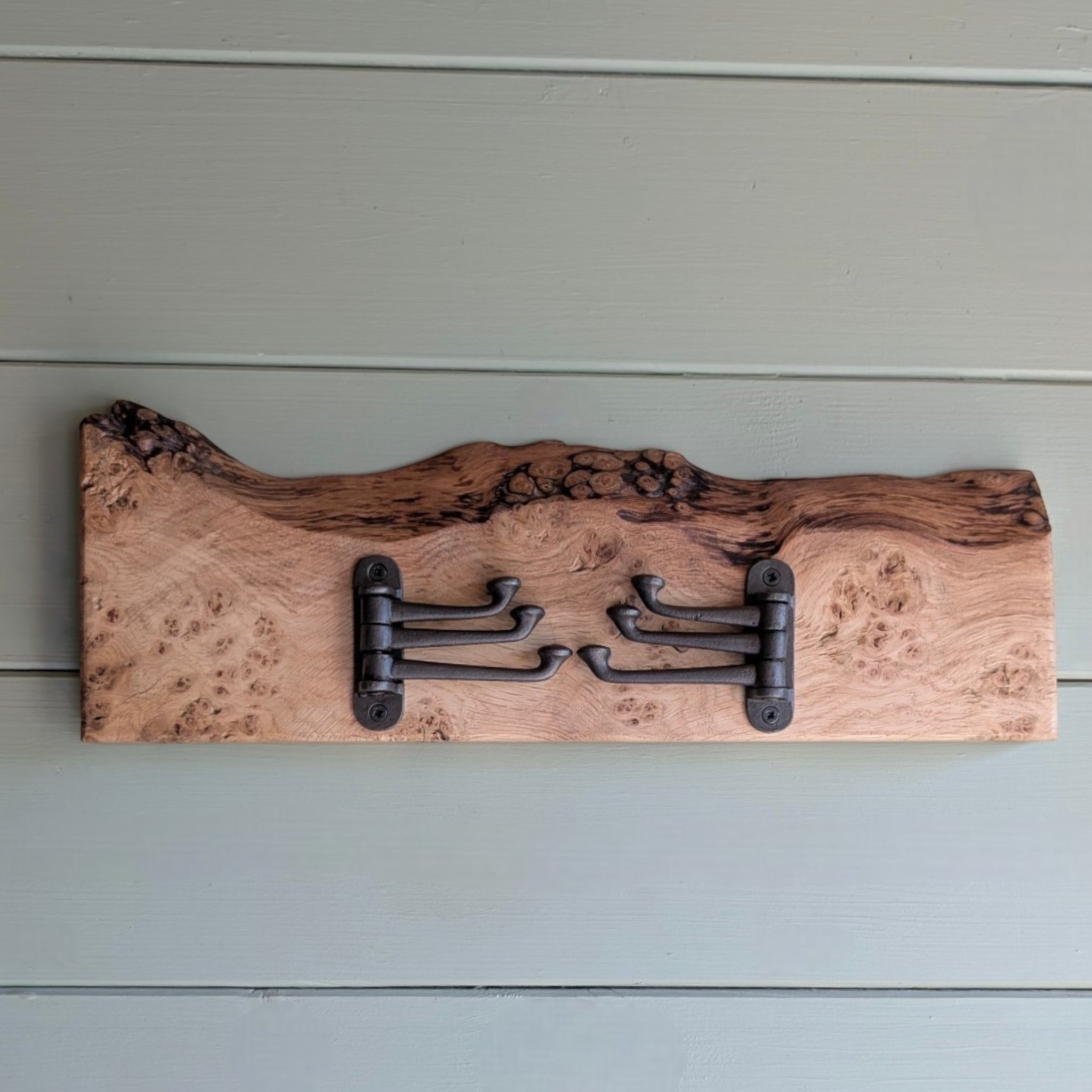 Thriverton hand-crafted pippy oak coat rack with a natural live-edge profile and rustic cast-iron hooks.