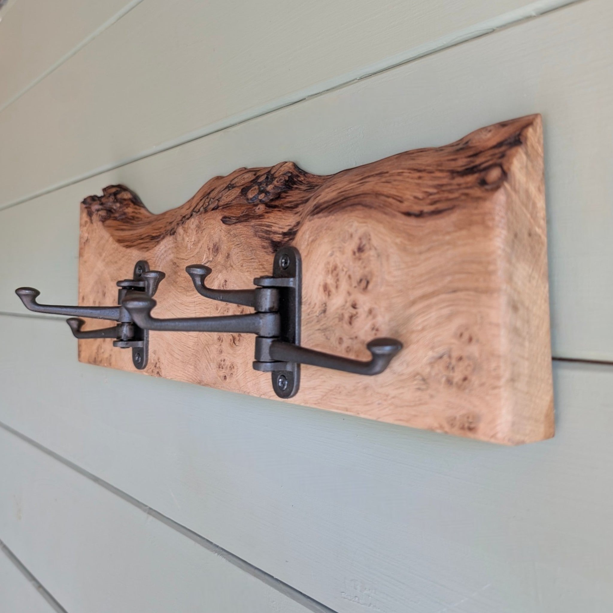 Thriverton hand-crafted live edge pippy oak coat rack with rustic natural wood grain and black cast-iron hooks