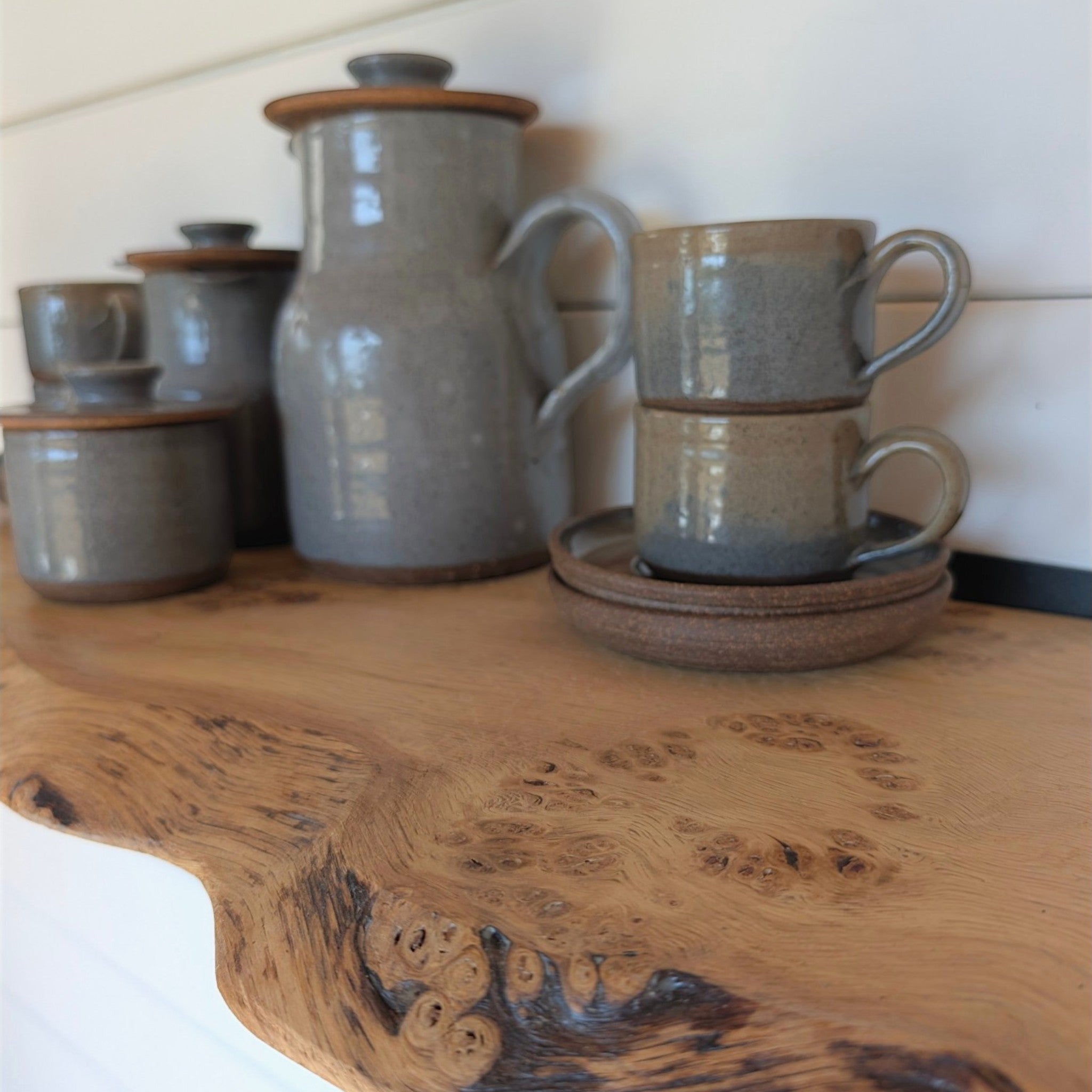 Thriverton live edge pippy oak shelf with natural wood grain and pips, holding grey ceramic kitchenware