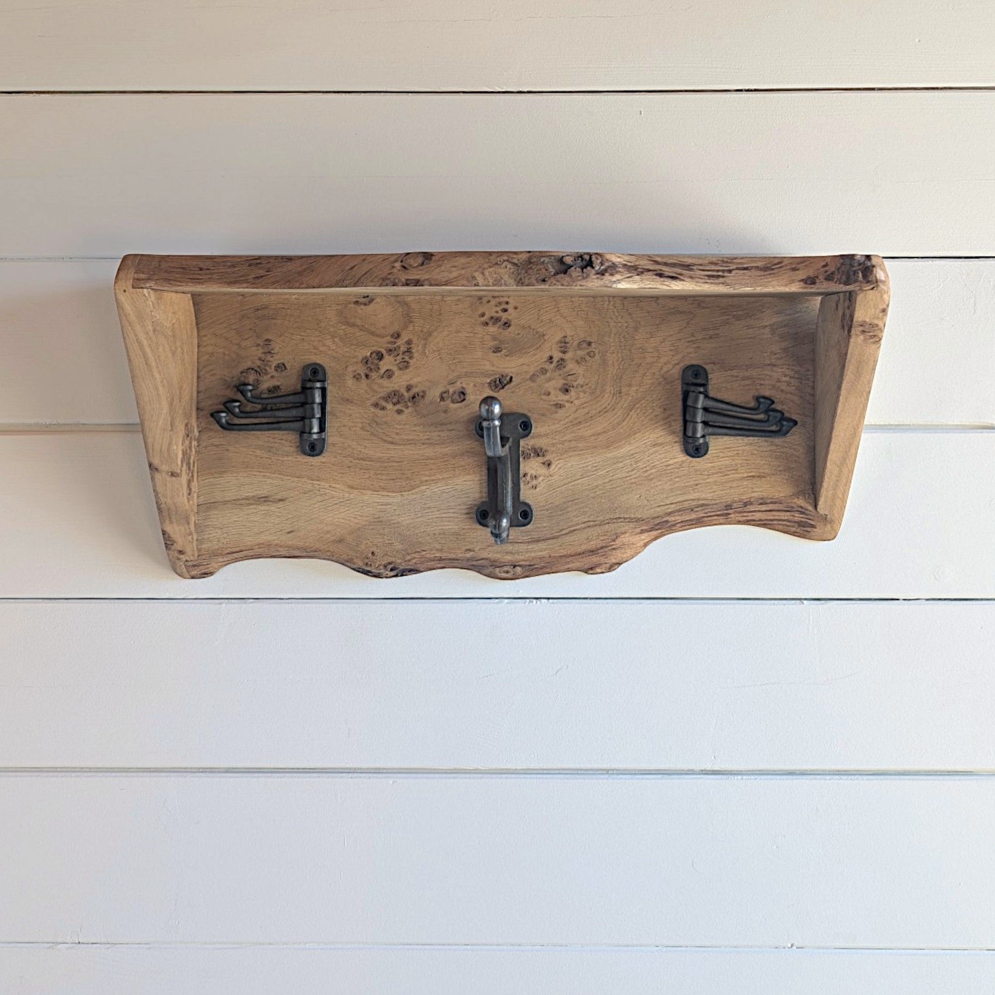 Thriverton live edge pippy oak coat rack with integrated shelf and three rustic cast iron hooks on white wall